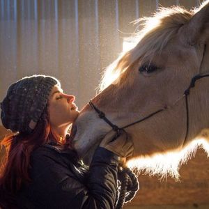 Cara Whitney has a moment of peace with one of her horses.
