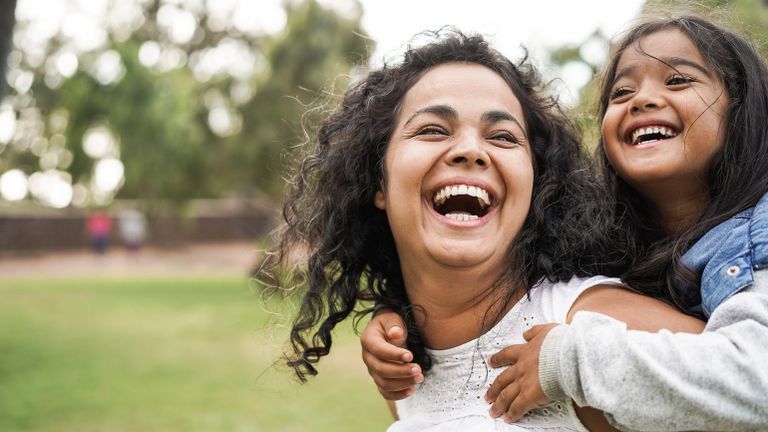 Mother and daughter laughing outside to celebrate types of valentines