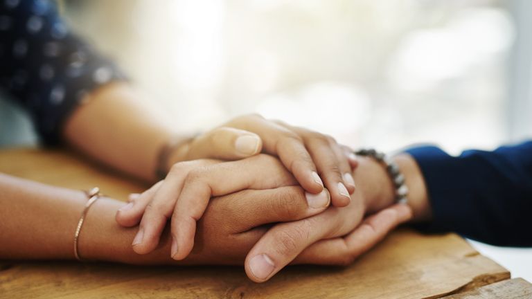 Hands clasped in forgiveness