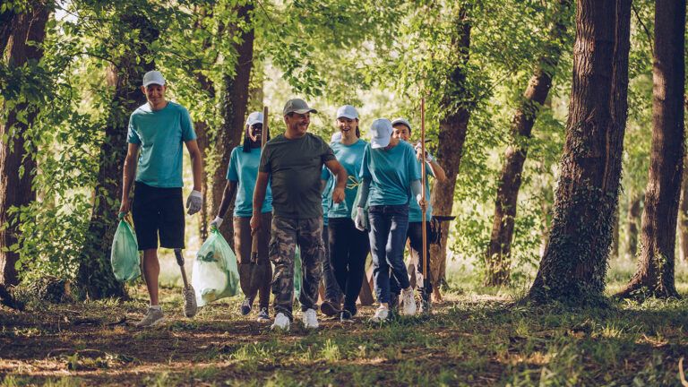 A group of young people volunteering at a local park for their spring activities