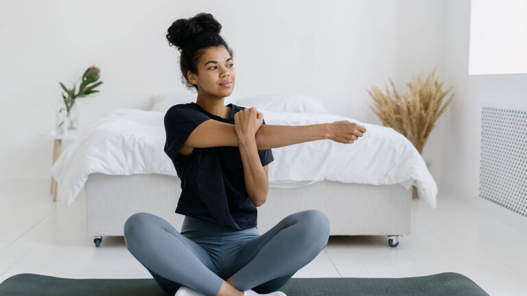 Woman doing her spring activity of stretching on a yoga mat