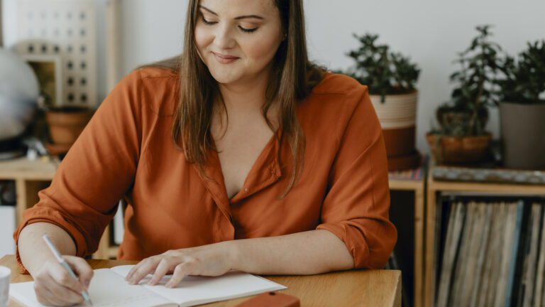 Woman writing her spring activities in her gratitude journal